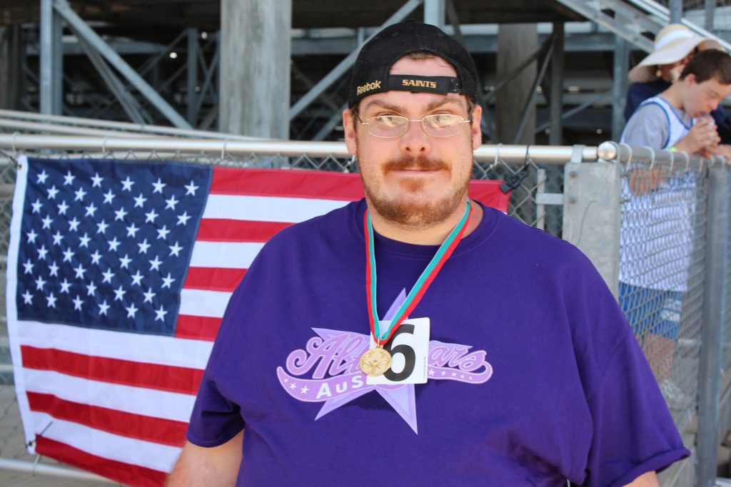 Resident Bryce wears a winning medal at the Special Olympics